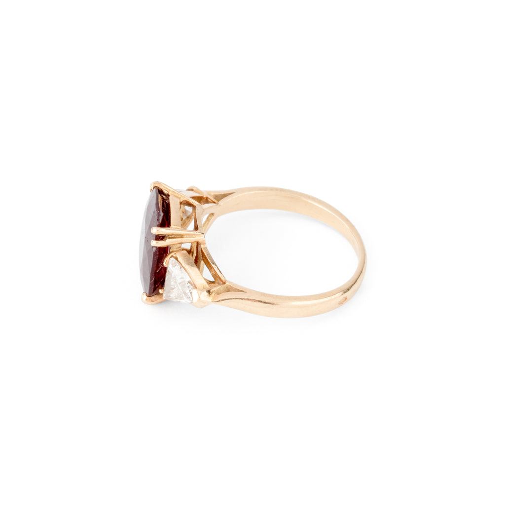 Oval ruby ring with two triangular diamonds