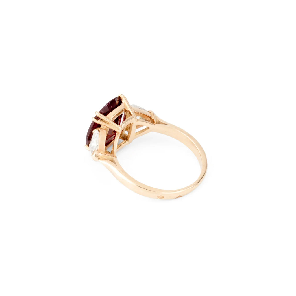 Oval ruby ring with two triangular diamonds