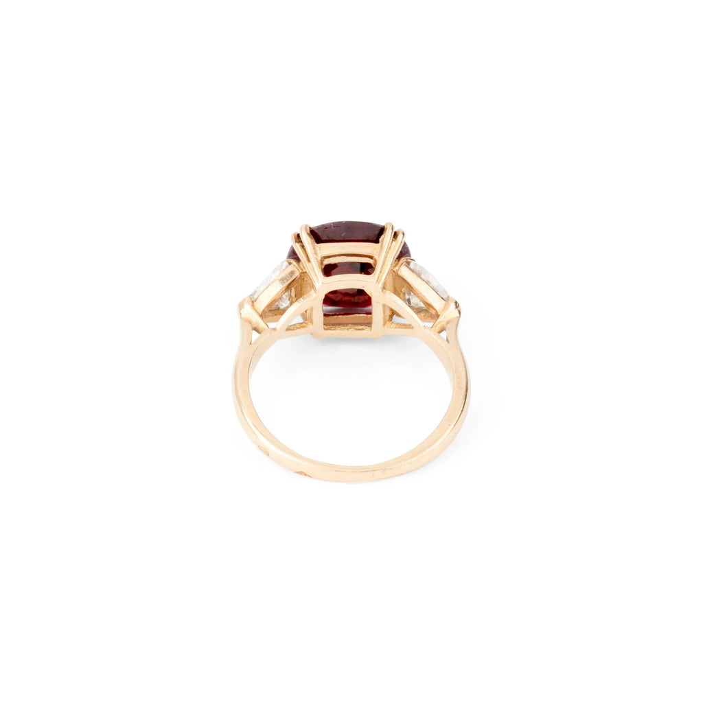 Oval ruby ring with two triangular diamonds
