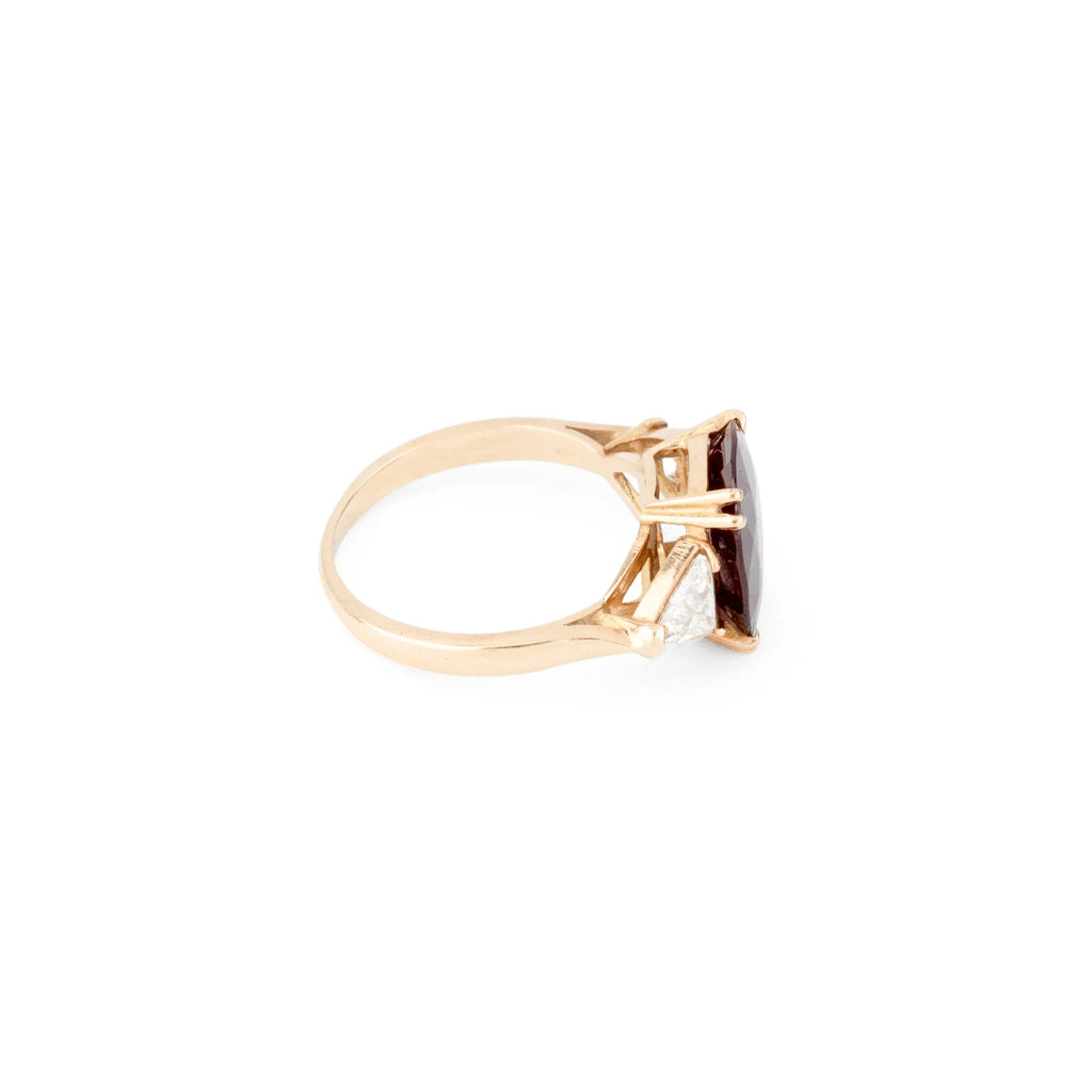 Oval ruby ring with two triangular diamonds