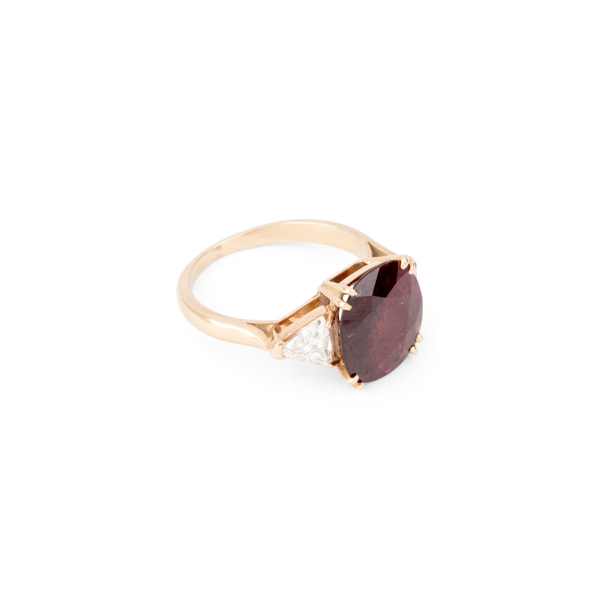 Oval ruby ring with two triangular diamonds