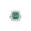 Bague en or gris avec Emeraude entourée de diamants