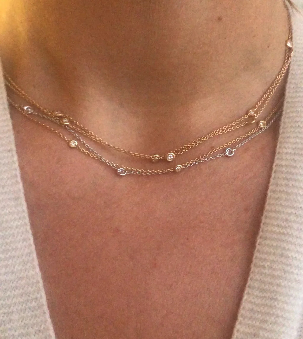 Yellow gold necklace with diamond-set links on a cable chain