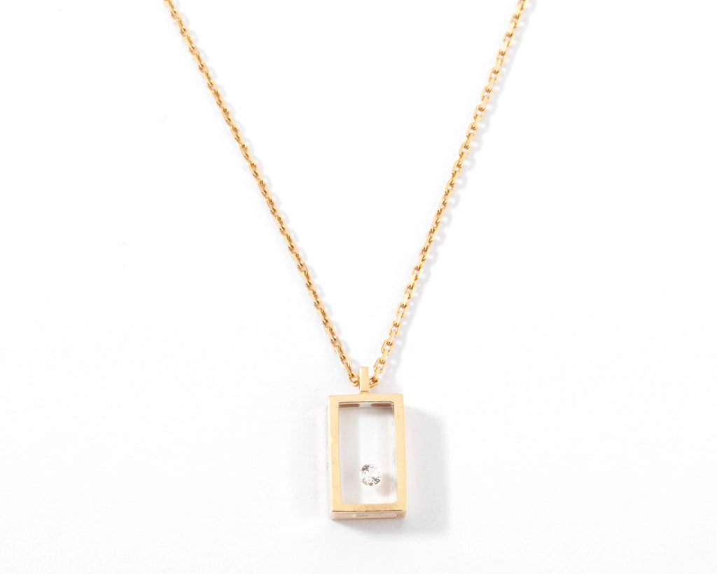Yellow gold and diamond necklace on Plexiglas by designer Pascal Morabito, Cube model