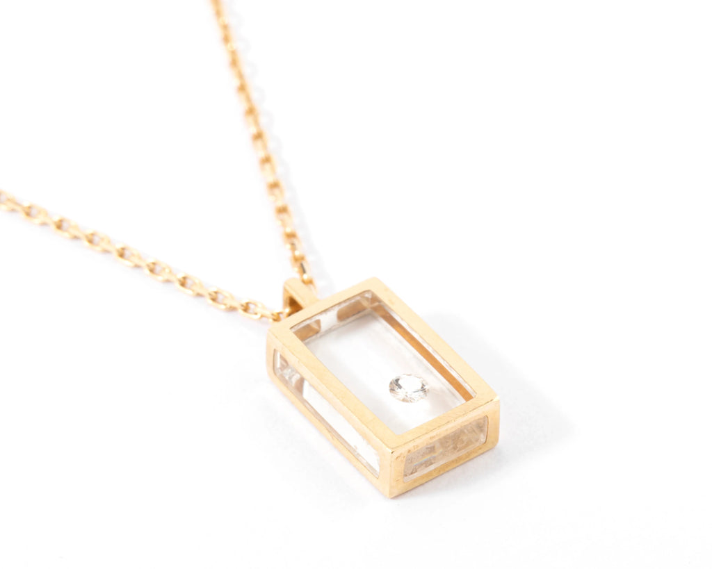 Yellow gold and diamond necklace on Plexiglas by designer Pascal Morabito, Cube model