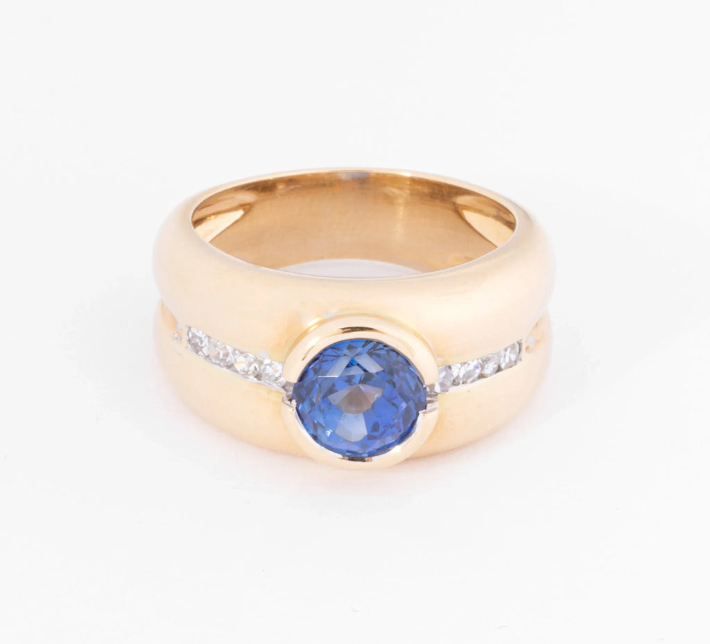 Yellow gold hoop ring adorned with a round-cut sapphire and diamond