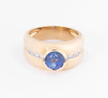 Yellow gold hoop ring adorned with a round-cut sapphire and diamond