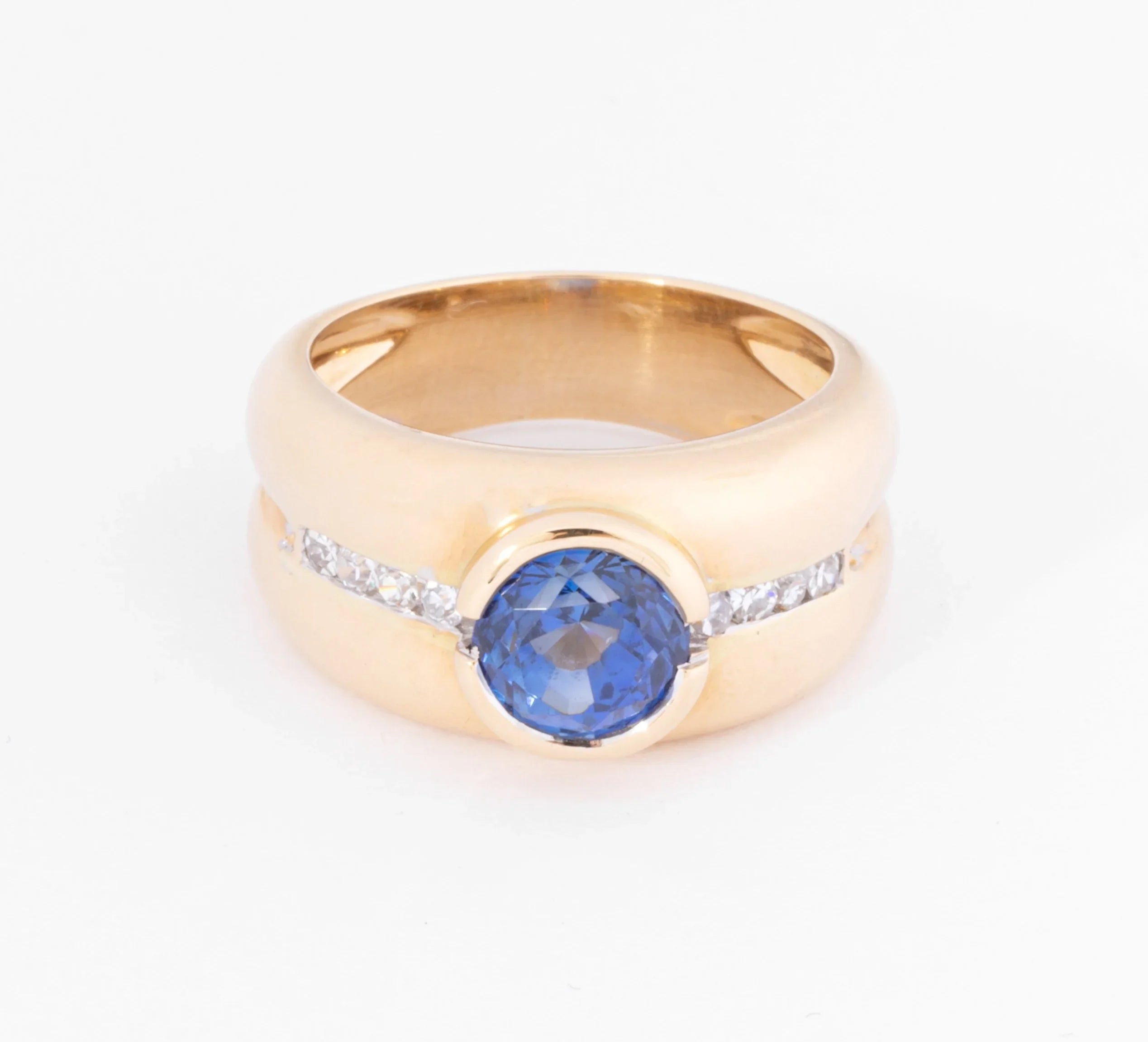 Yellow gold hoop ring adorned with a round-cut sapphire and diamond