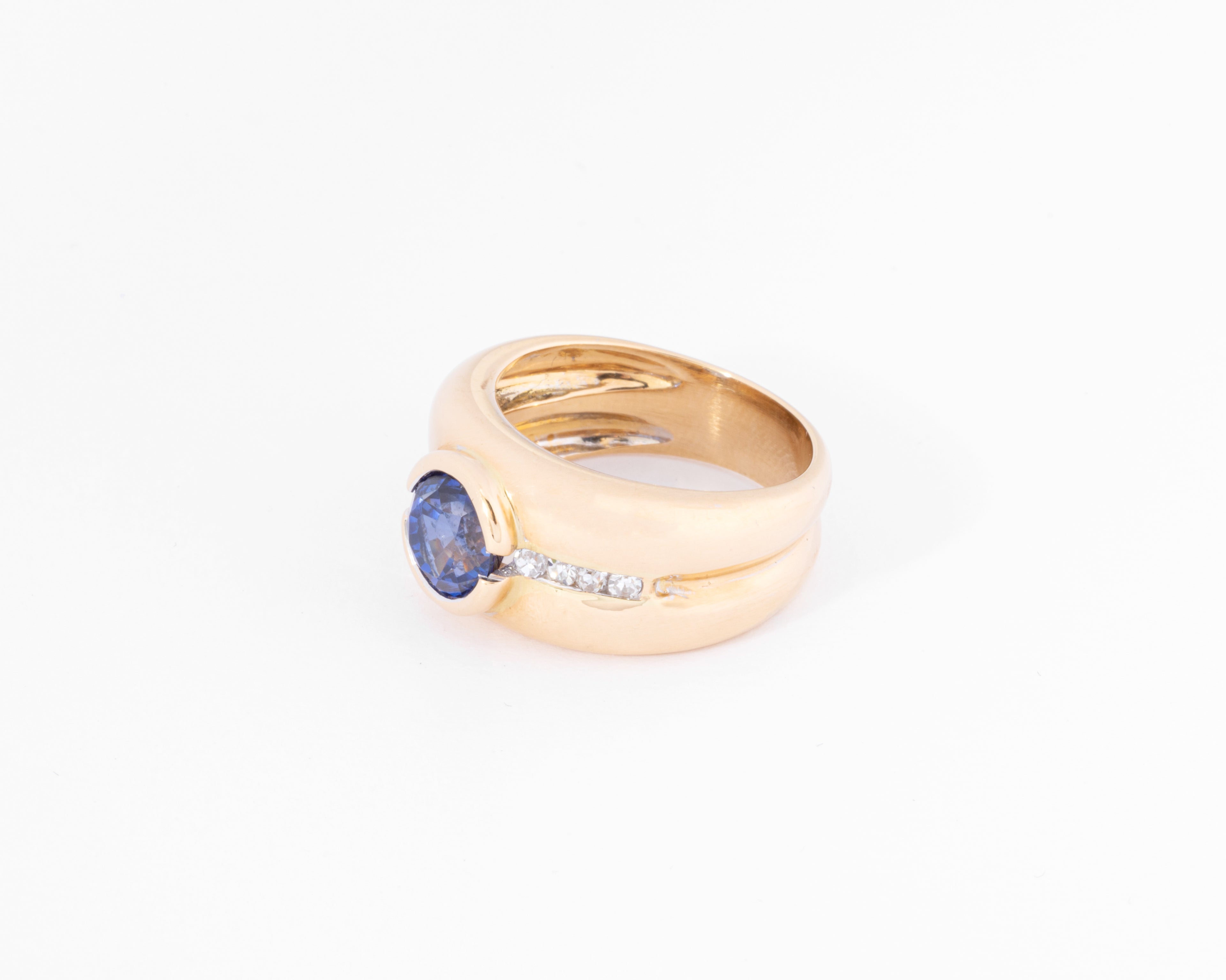 Yellow gold hoop ring adorned with a round-cut sapphire and diamond