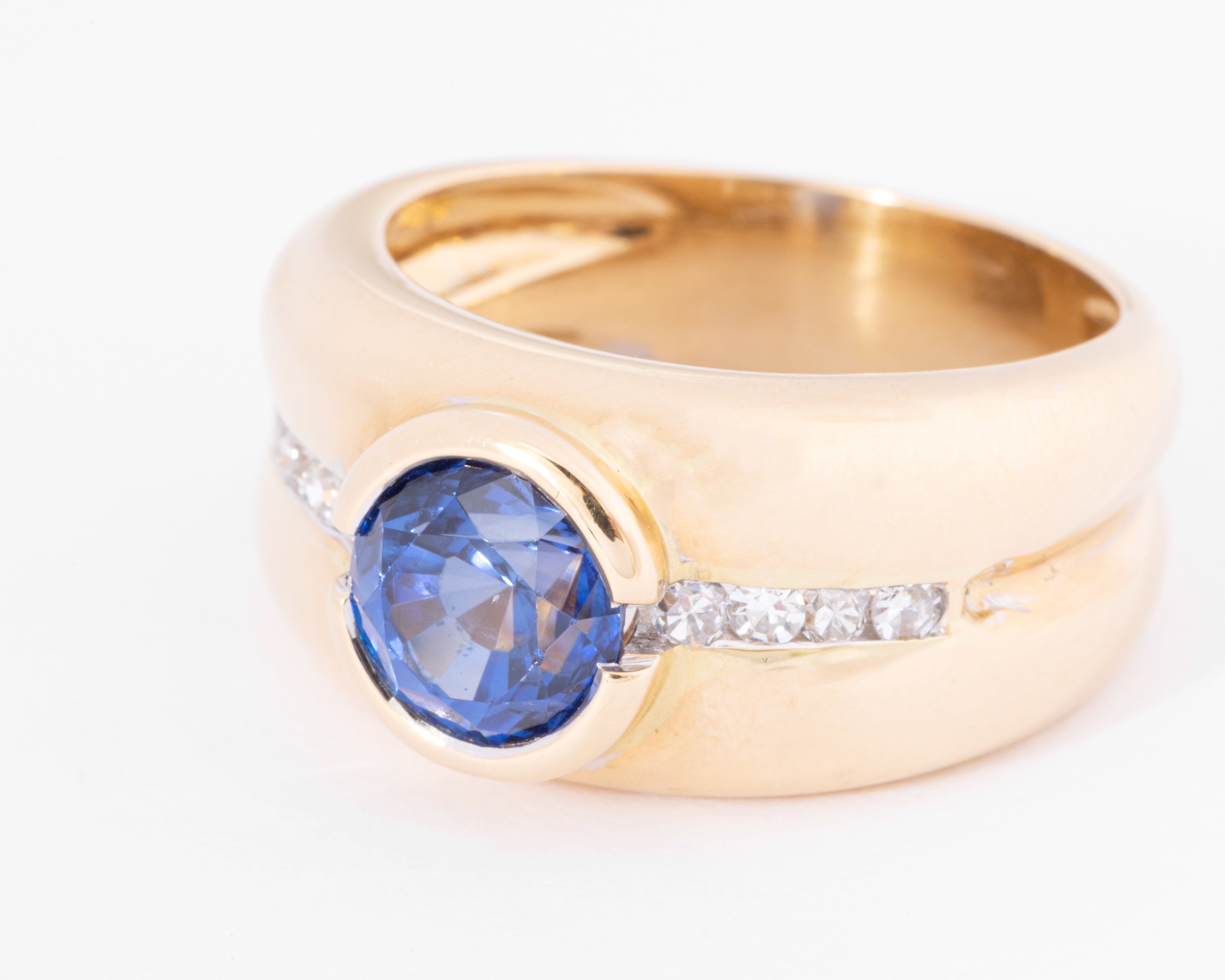 Yellow gold hoop ring adorned with a round-cut sapphire and diamond