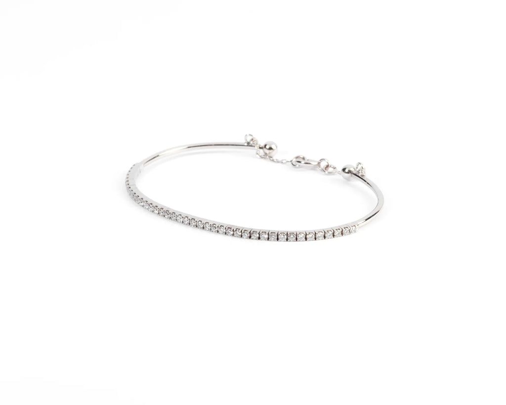 Half-bangle bracelet in white gold with diamond on top