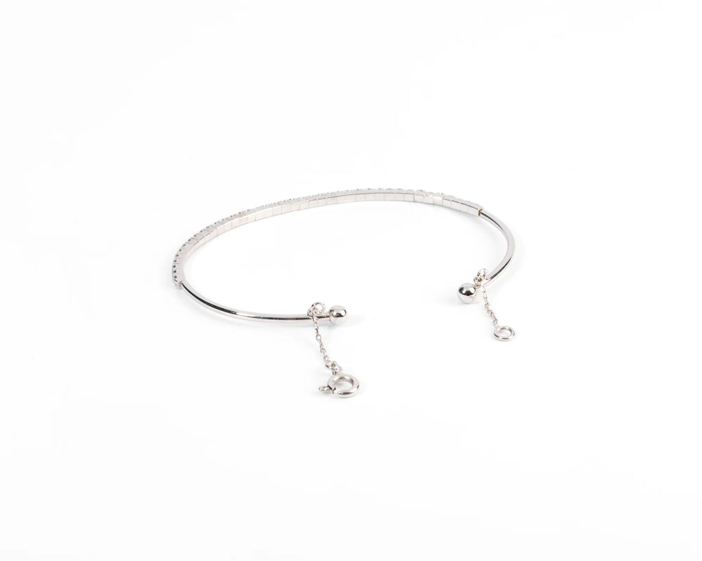 Half-bangle bracelet in white gold with diamond on top