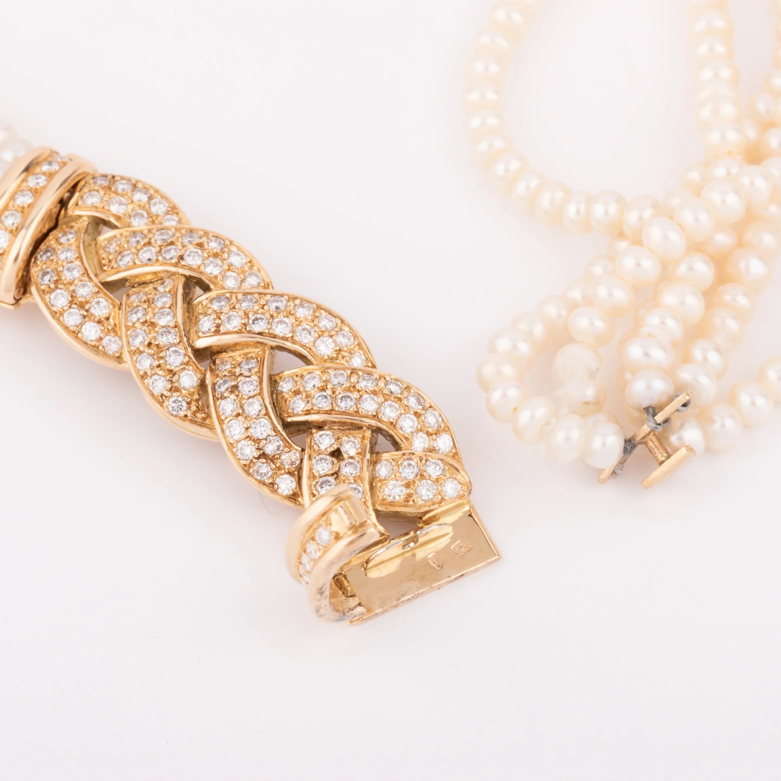 Multi-strand pearl necklace with diamond clasp