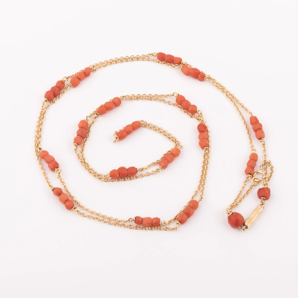Yellow gold necklace with faceted coral beads