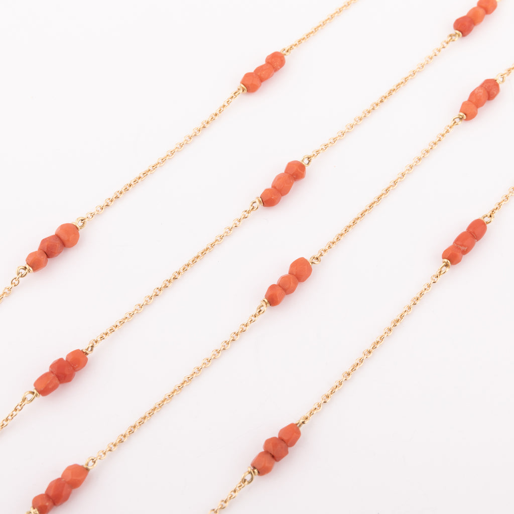Yellow gold necklace with faceted coral beads