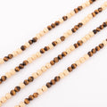 Sautoir en perles d'or ciselés et perle yeux de tigre