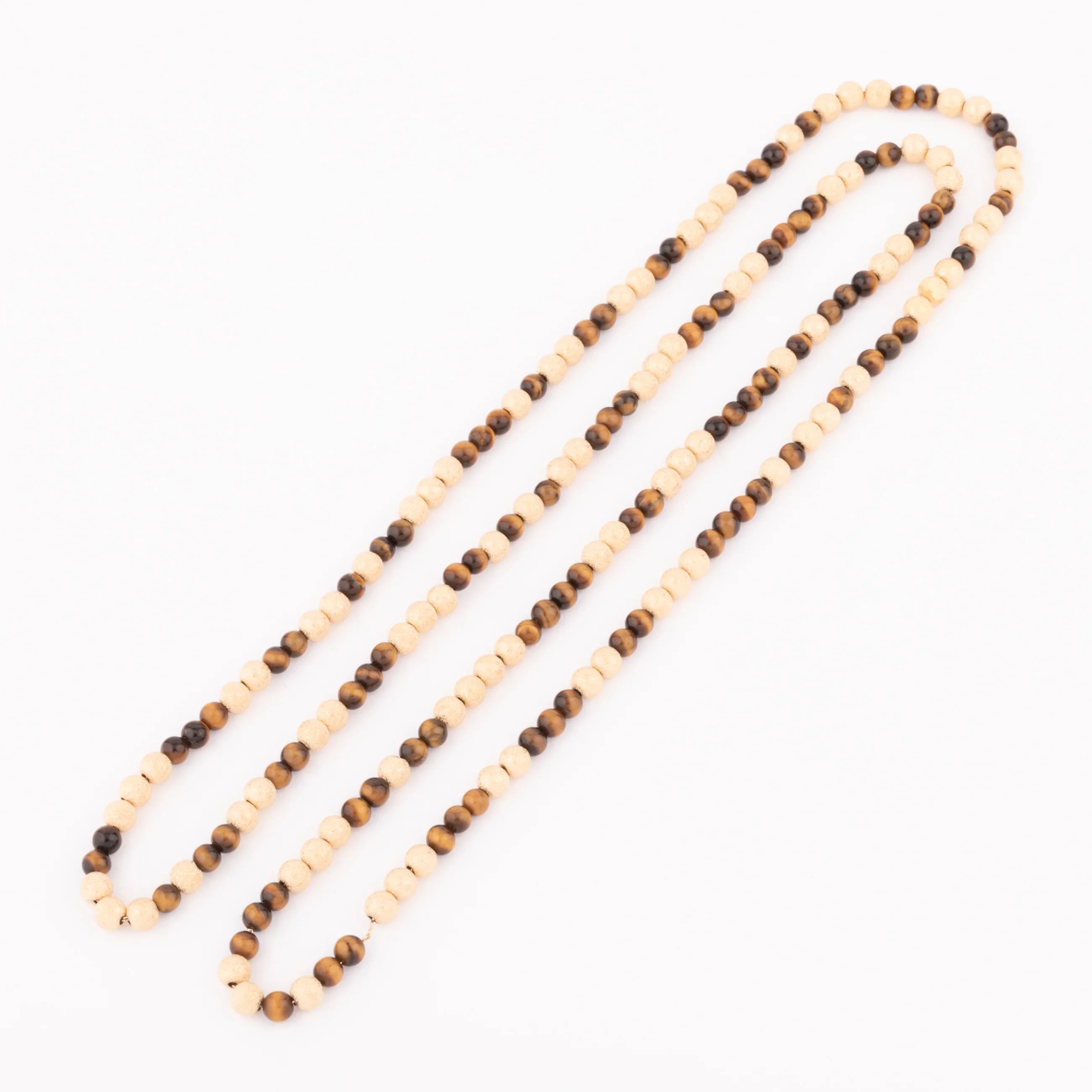Sautoir en perles d'or ciselés et perle yeux de tigre