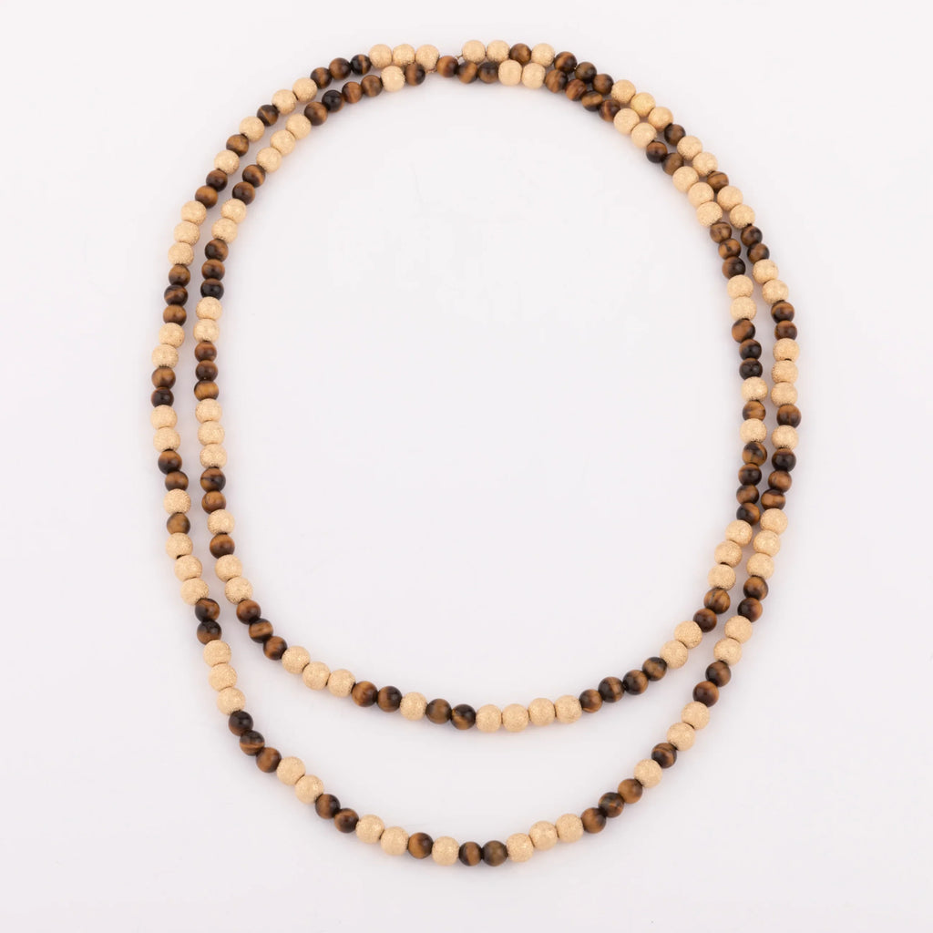 Sautoir en perles d'or ciselés et perle yeux de tigre