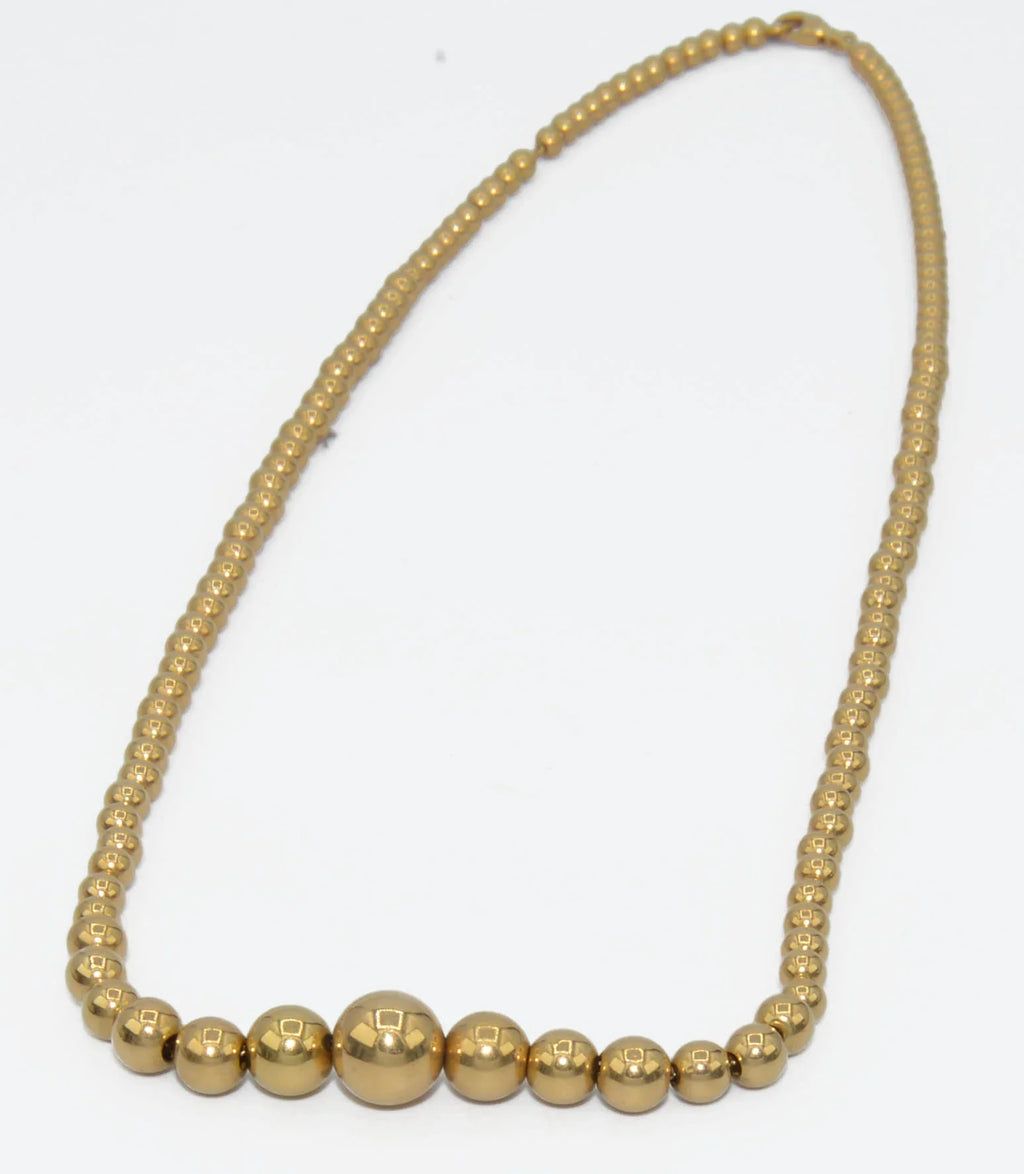 Marseille necklace adorned with gold beads