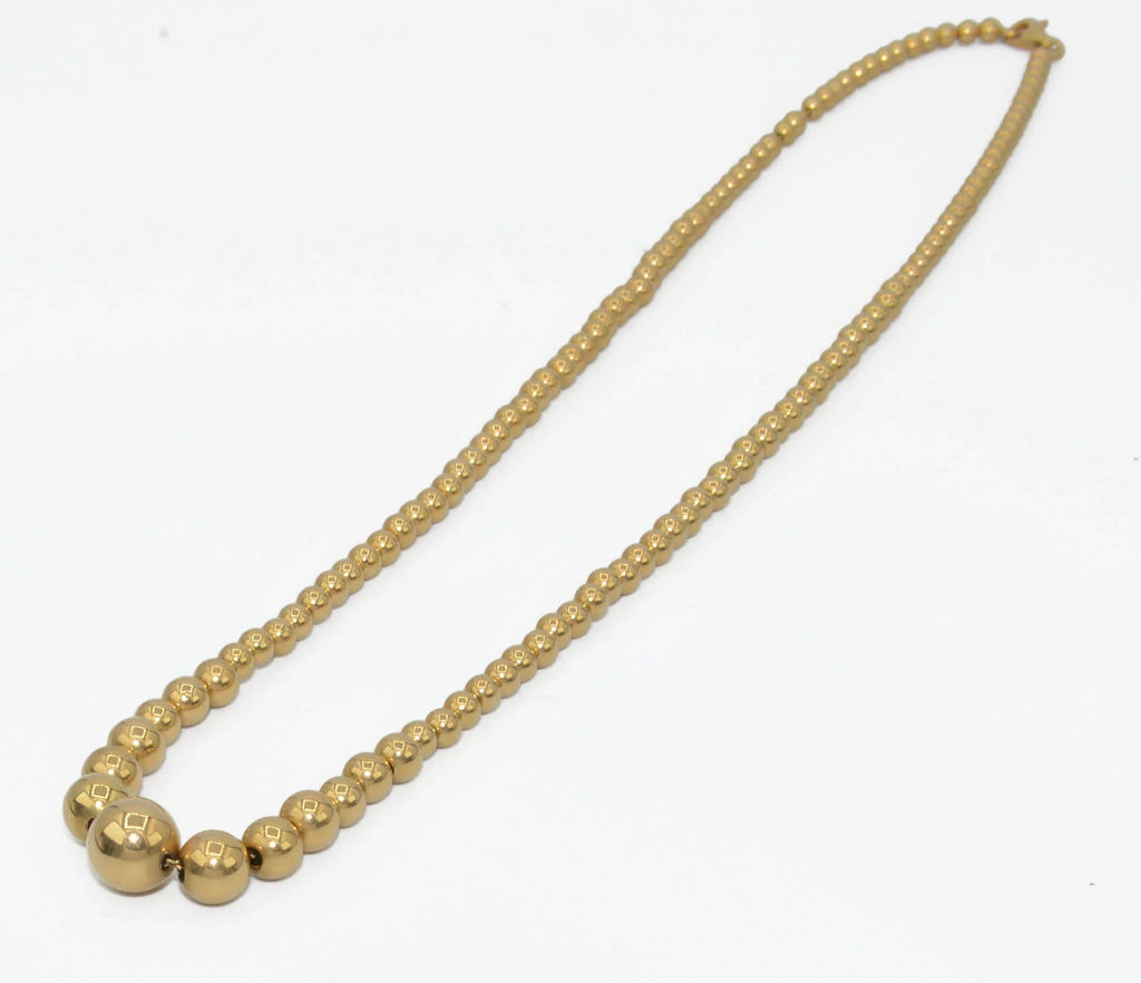 Marseille necklace adorned with gold beads