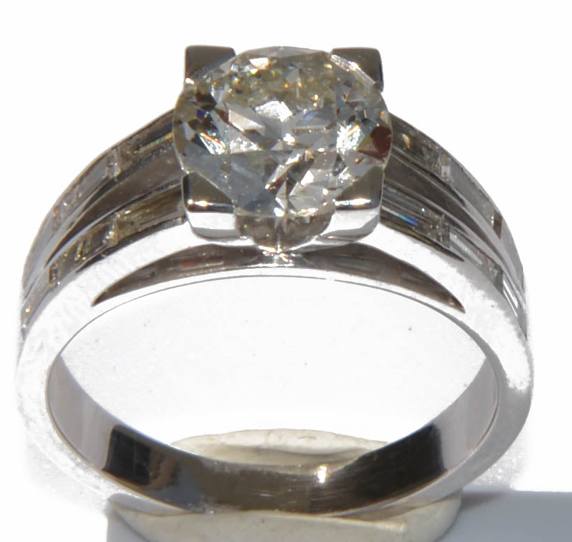 Solitaire ring with a diamond flanked by baguette diamonds
