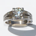 Solitaire ring with a diamond flanked by baguette diamonds