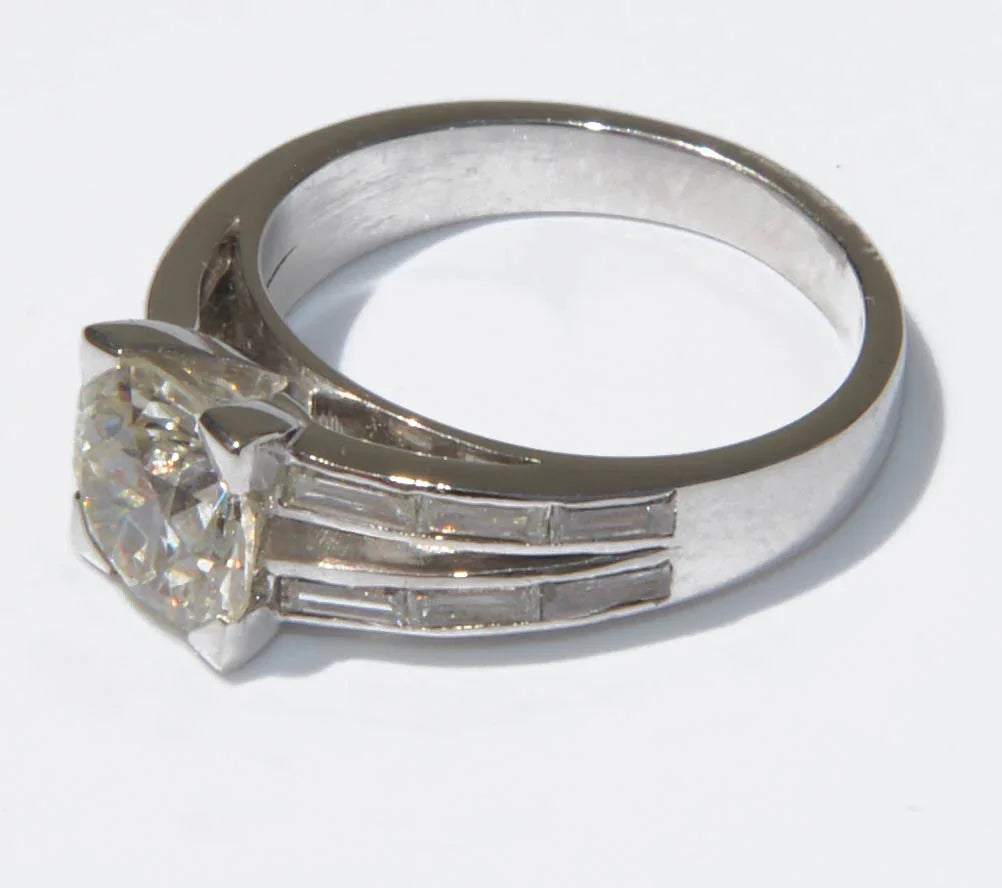 Solitaire ring with a diamond flanked by baguette diamonds