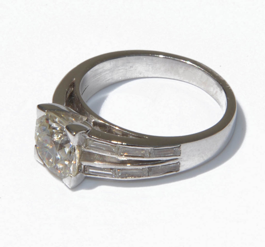 Solitaire ring with a diamond flanked by baguette diamonds