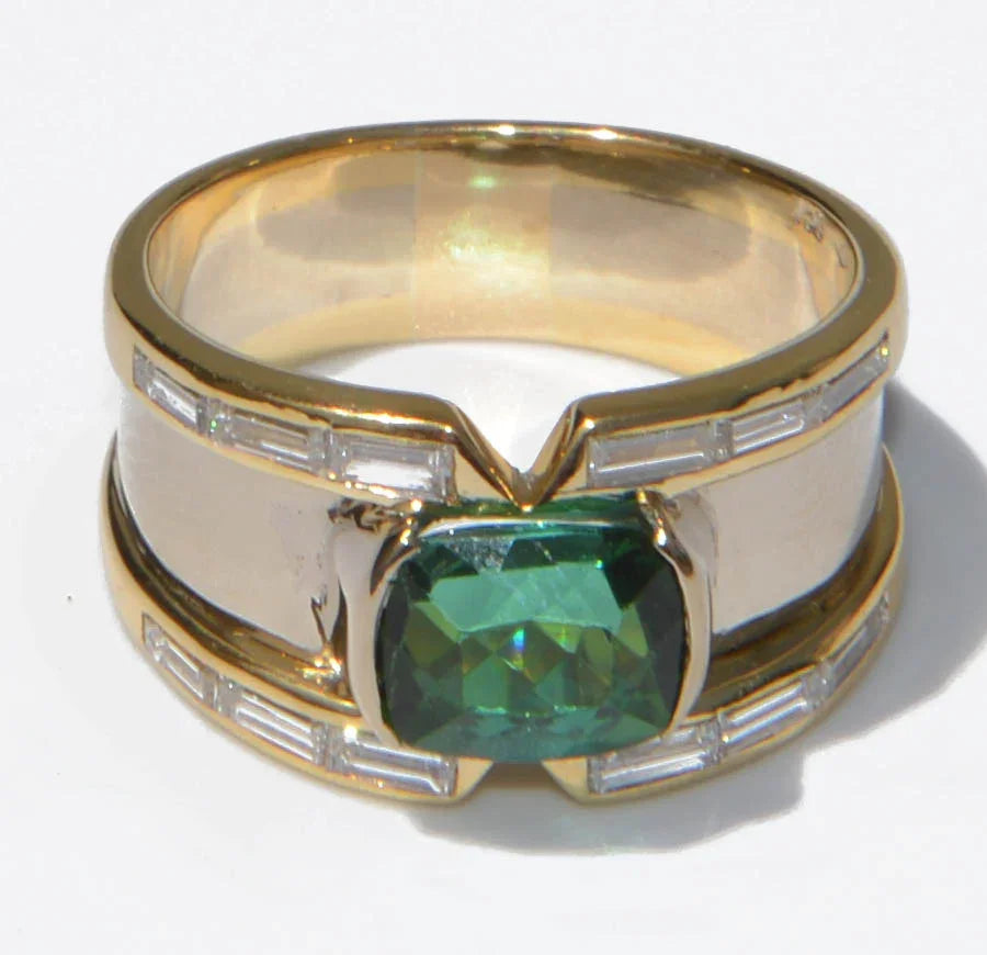 Yellow gold bangle ring adorned with a Tourmaline on a baguette diamond cascade