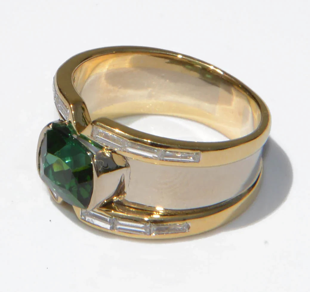 Yellow gold bangle ring adorned with a Tourmaline on a baguette diamond cascade