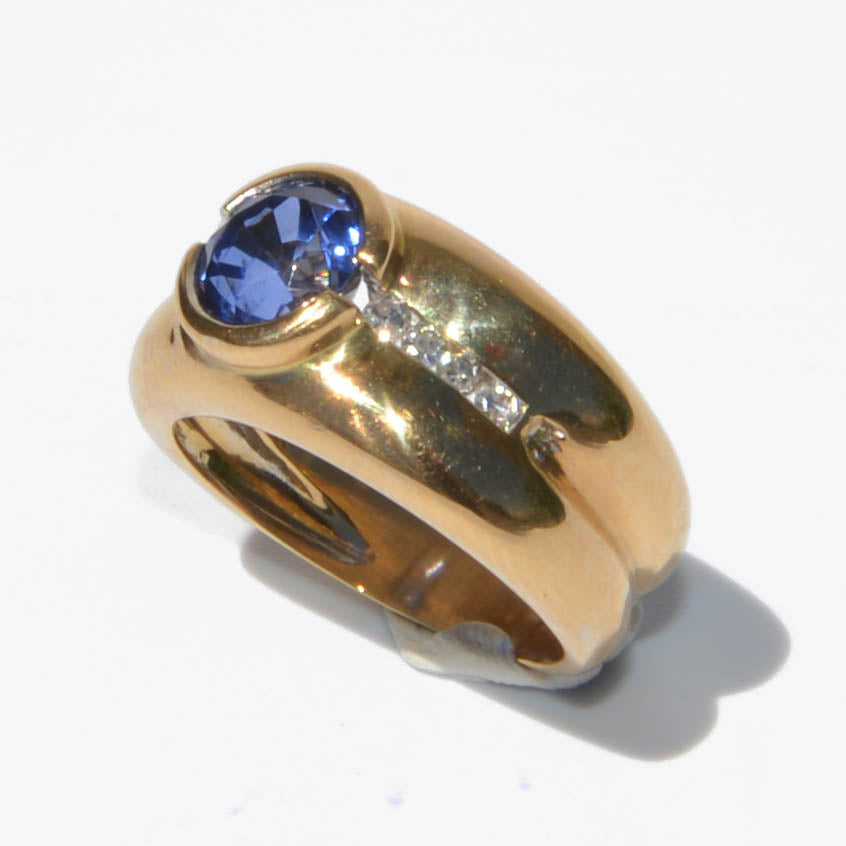 Yellow gold hoop ring adorned with a round-cut sapphire and diamond
