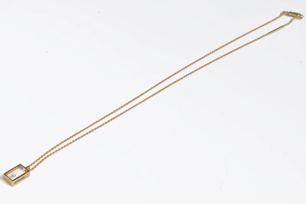Yellow gold and diamond necklace on Plexiglas by designer Pascal Morabito, Cube model