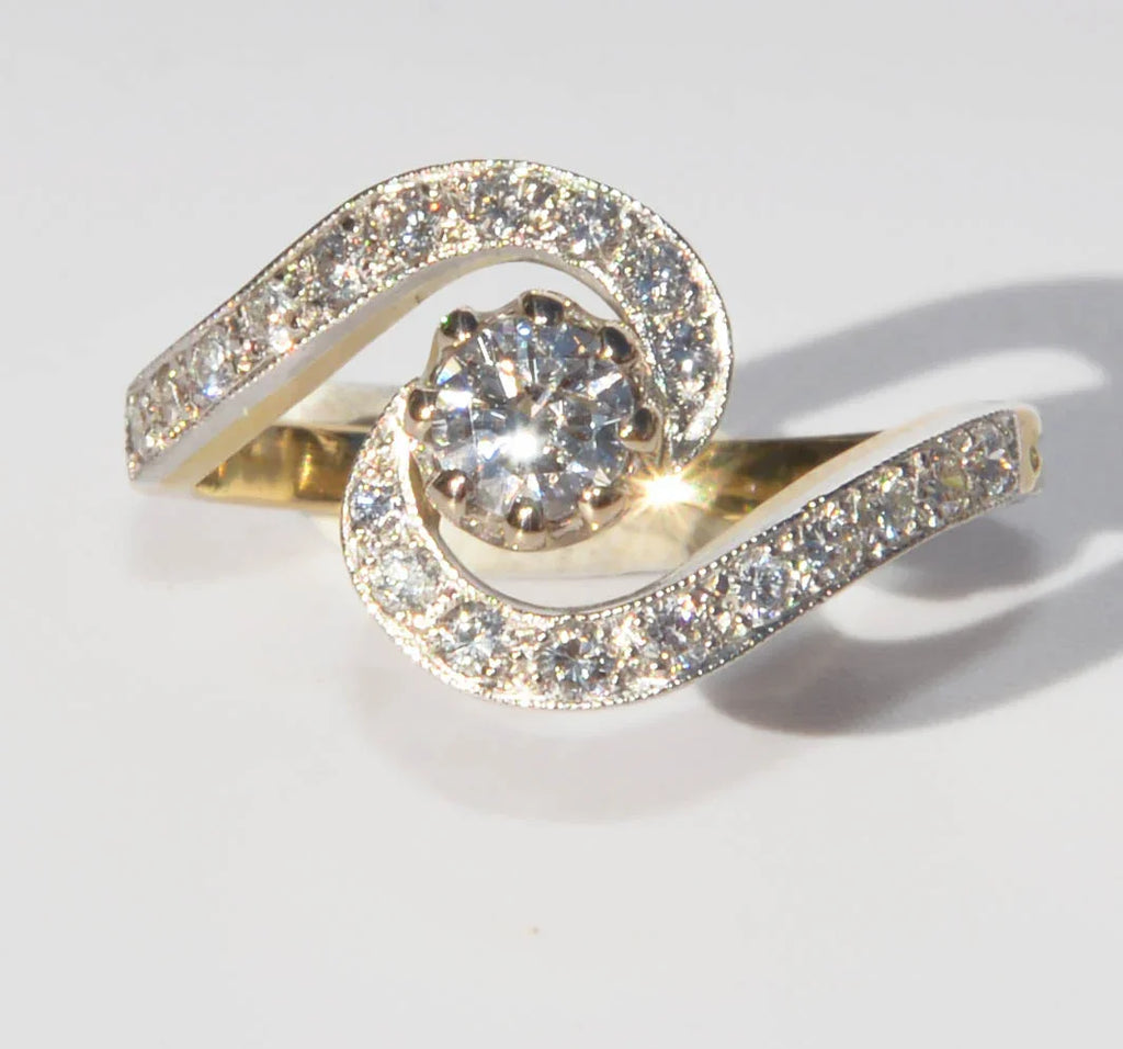 Yellow gold and platinum swirl ring with diamonds