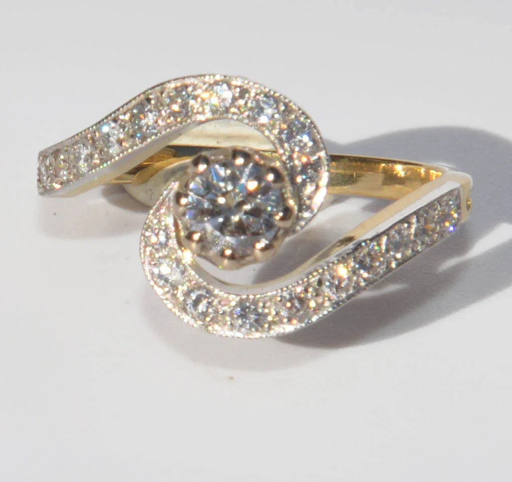 Yellow gold and platinum swirl ring with diamonds