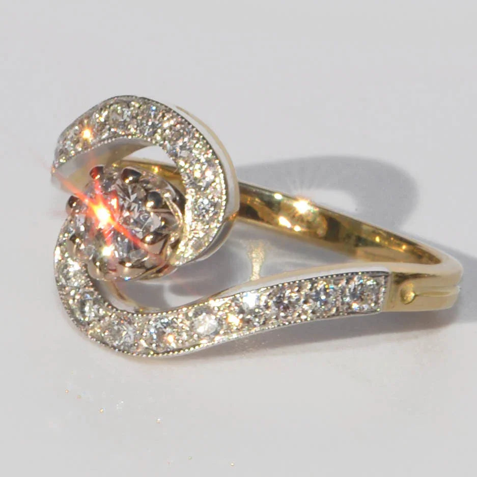 Yellow gold and platinum swirl ring with diamonds