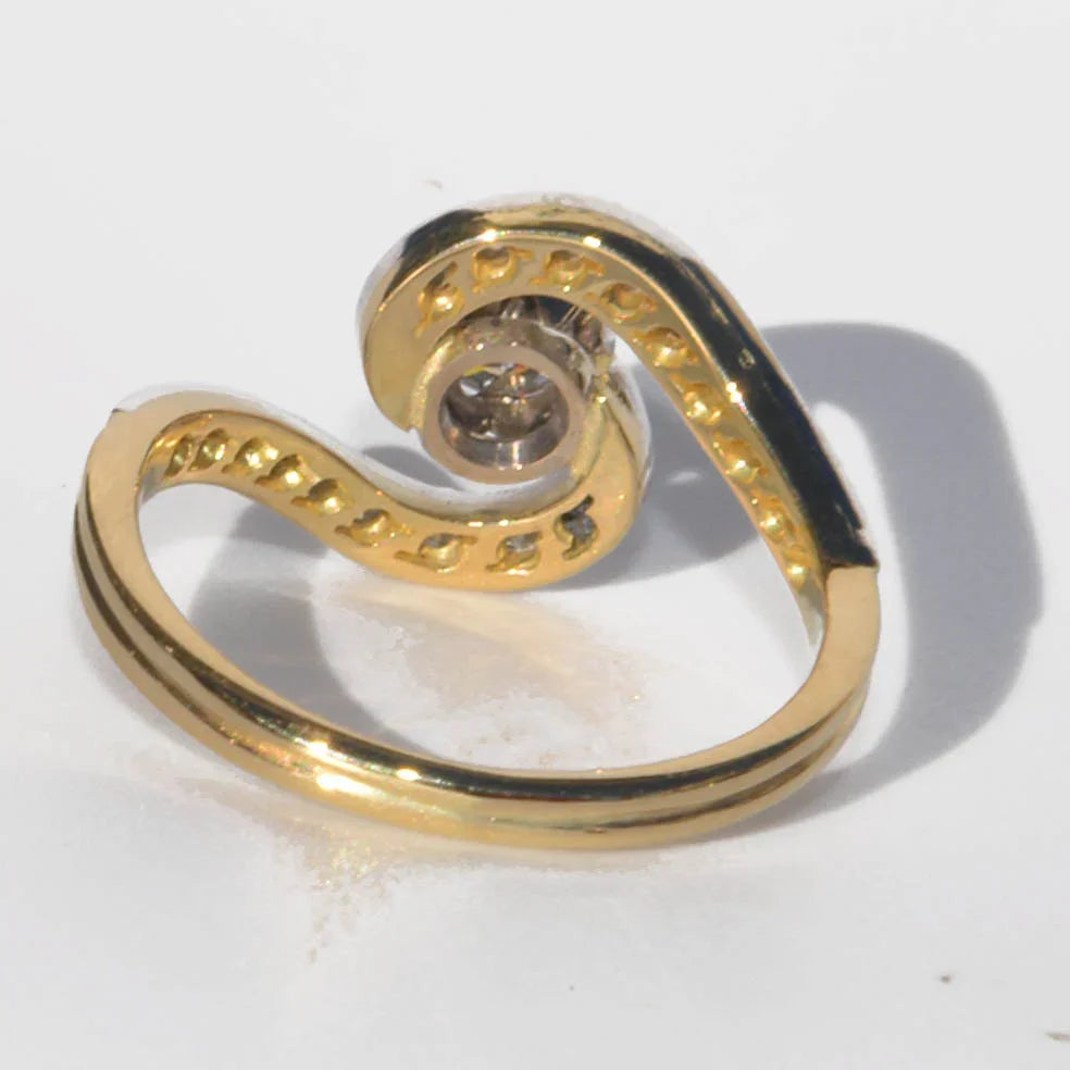 Yellow gold and platinum swirl ring with diamonds