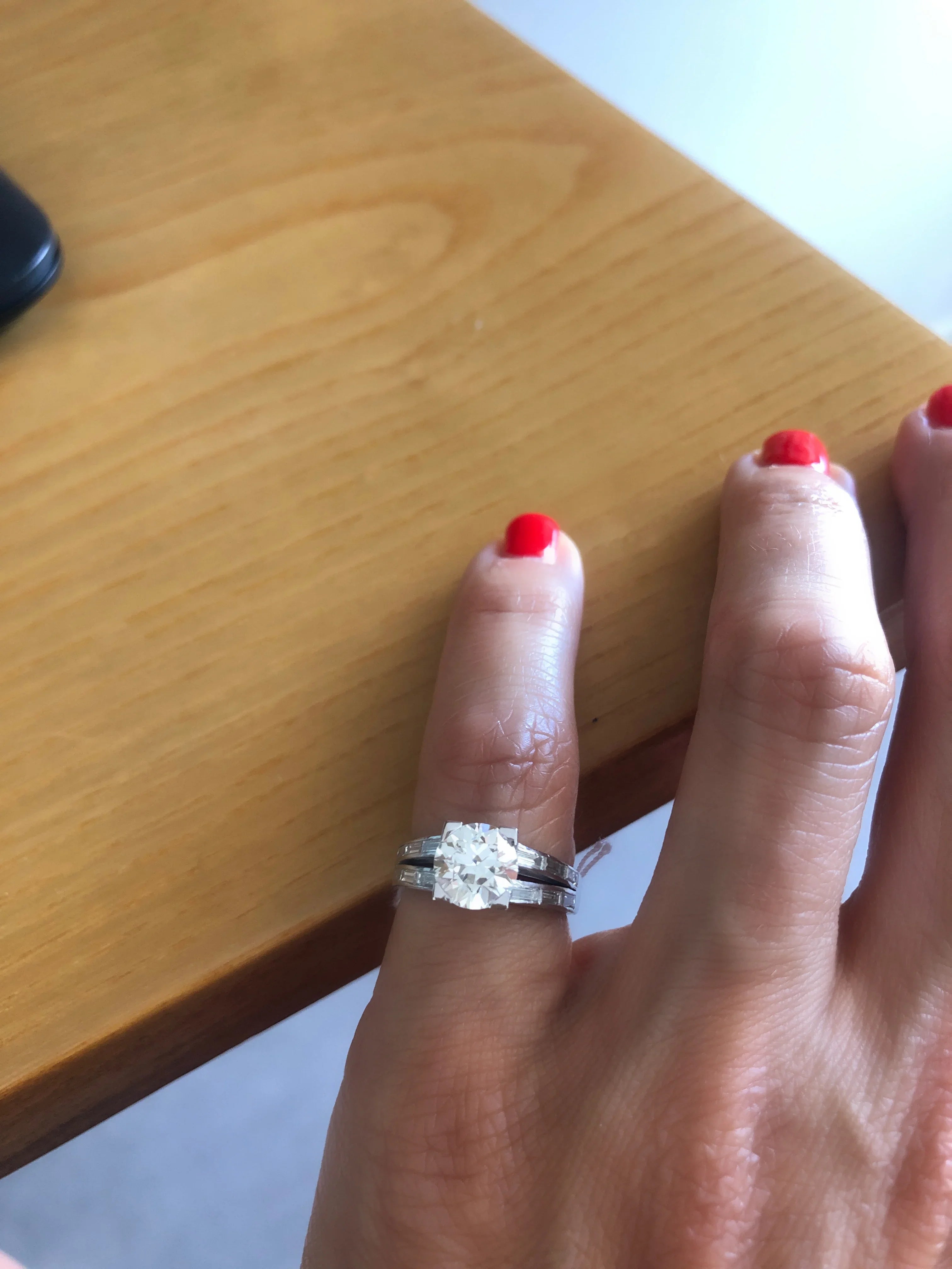 Solitaire ring with a diamond flanked by baguette diamonds