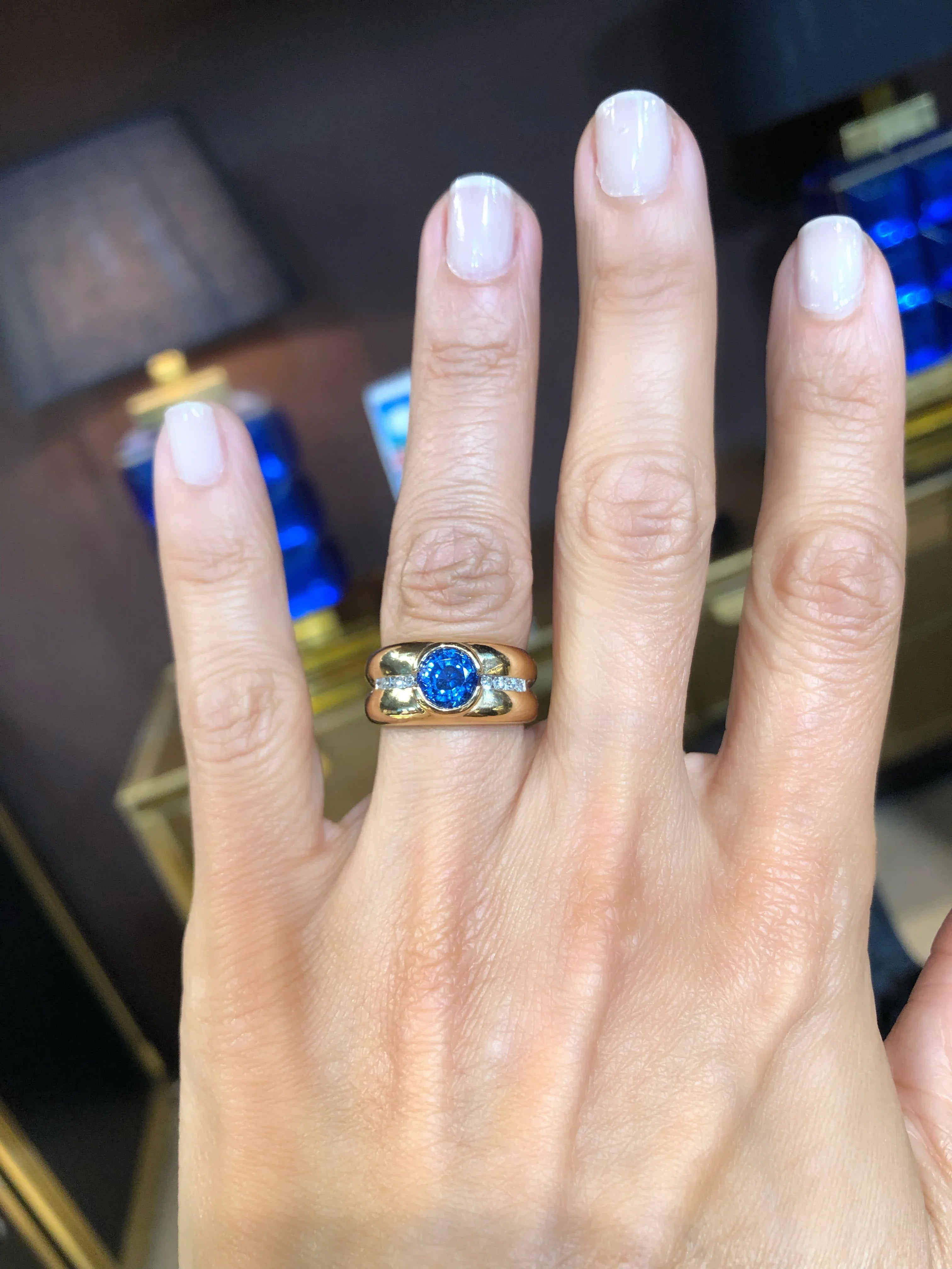 Yellow gold hoop ring adorned with a round-cut sapphire and diamond