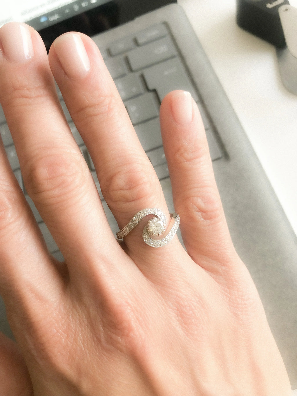 Yellow gold and platinum swirl ring with diamonds
