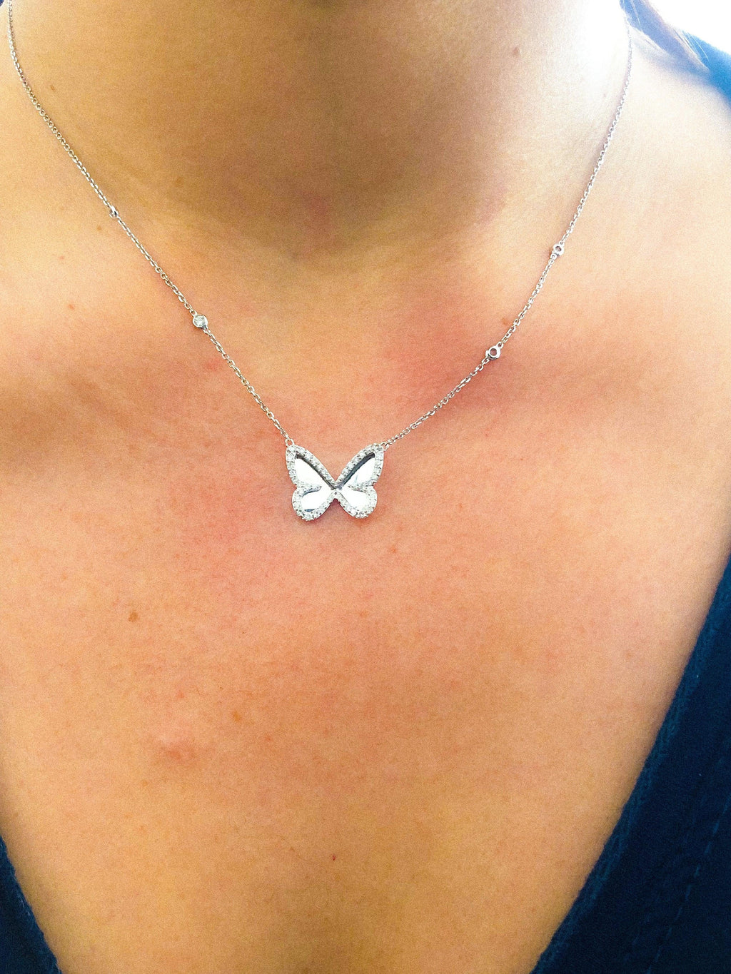 White gold diamond pendant with a butterfly pendant