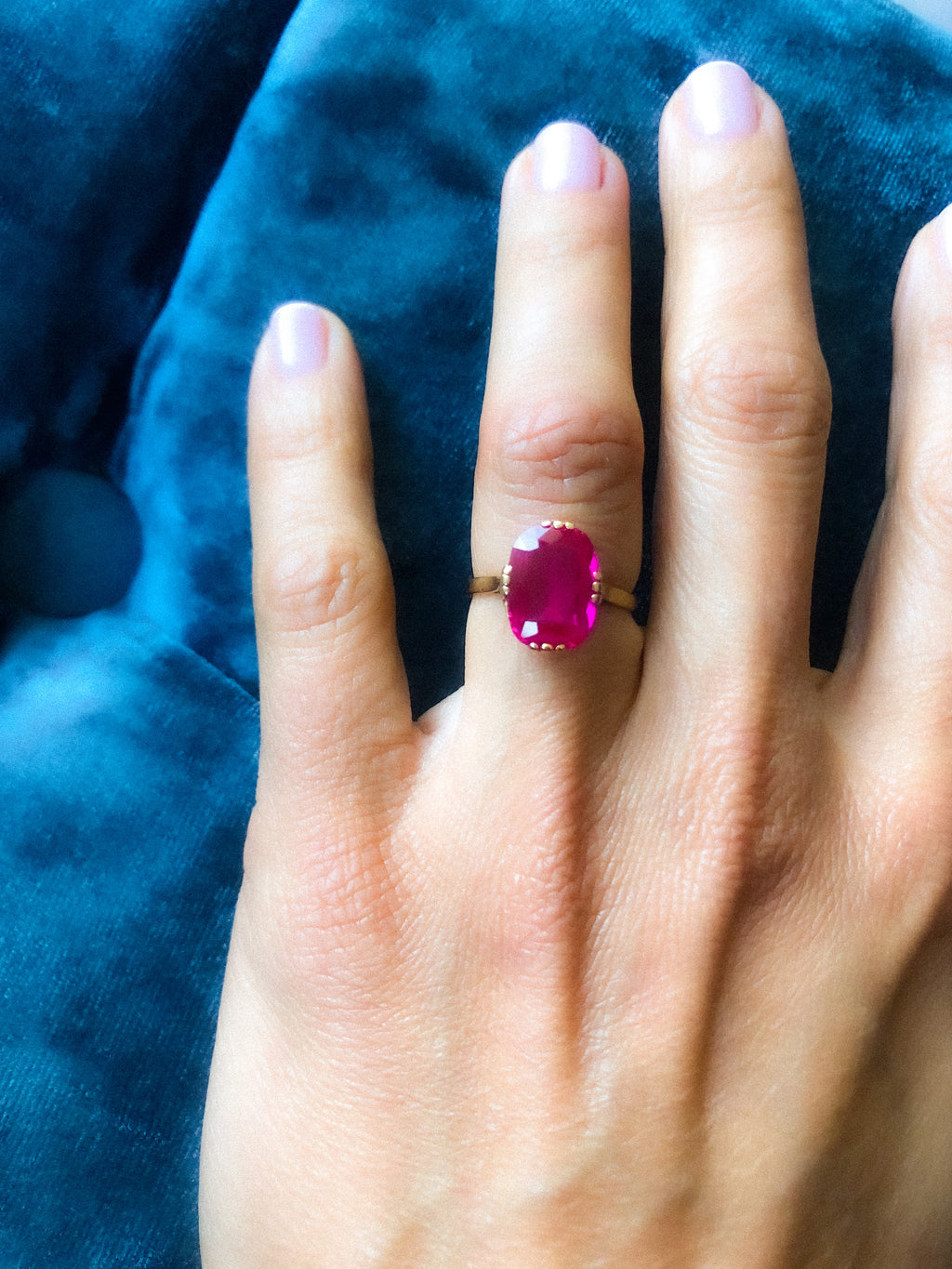 Yellow gold ring adorned with a red stone