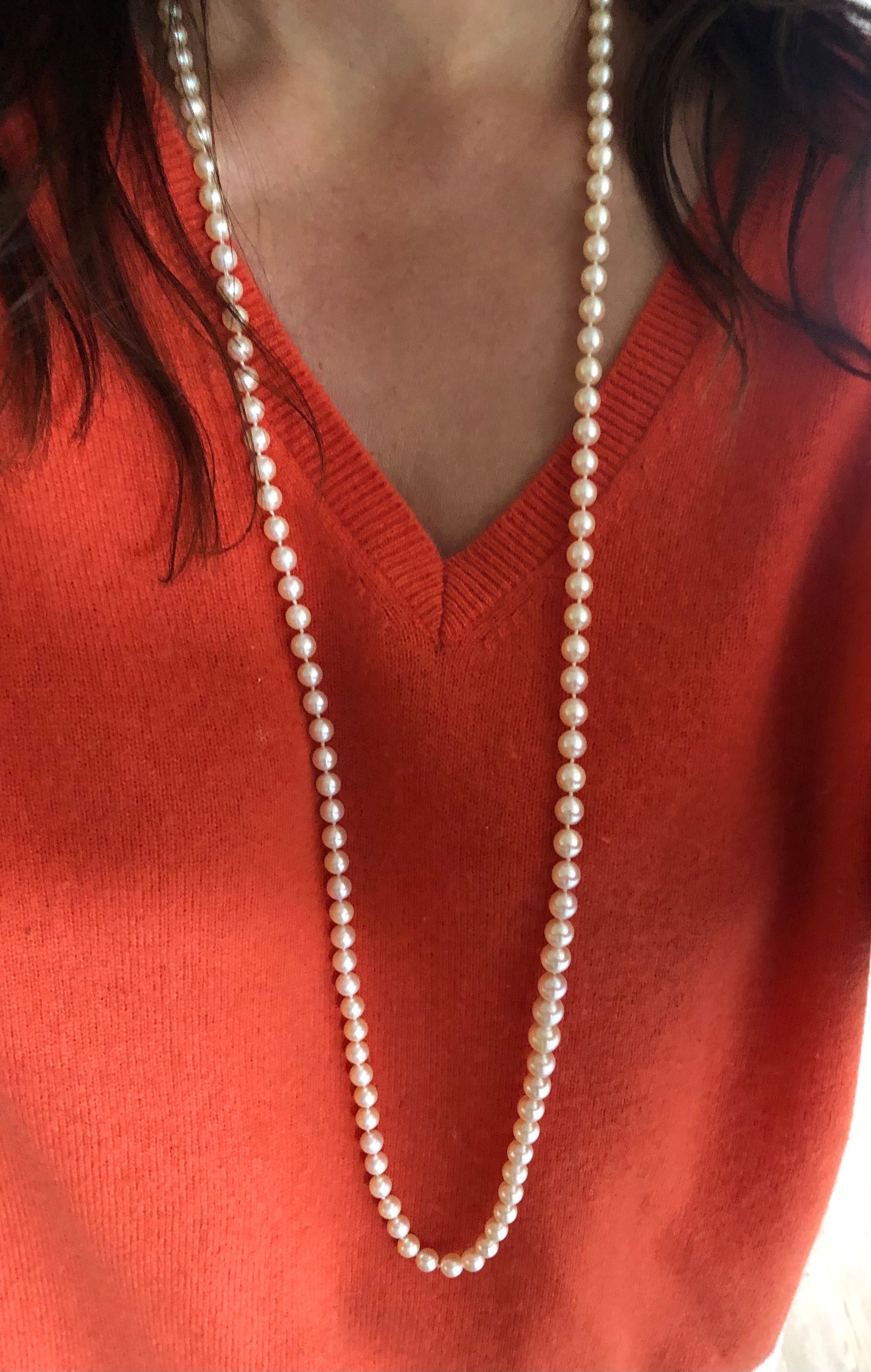 Long necklace with white Akoya Pearls.