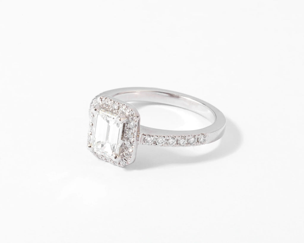 White gold solitaire ring with an emerald-cut diamond