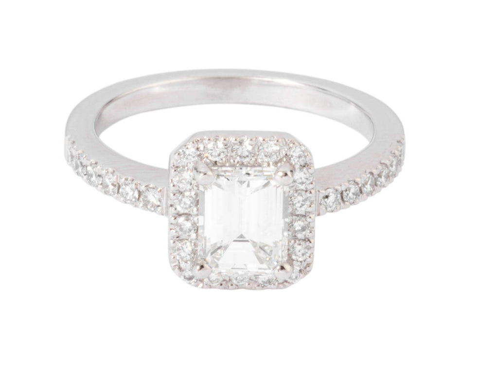 White gold solitaire ring with an emerald-cut diamond