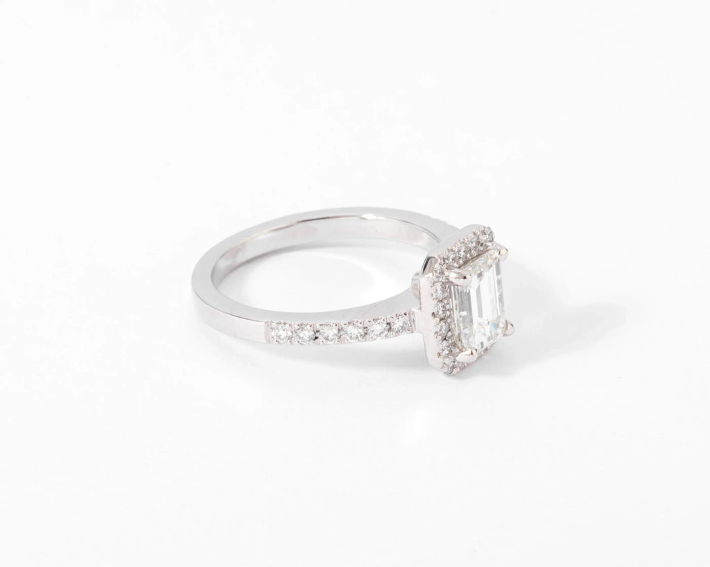White gold solitaire ring with an emerald-cut diamond