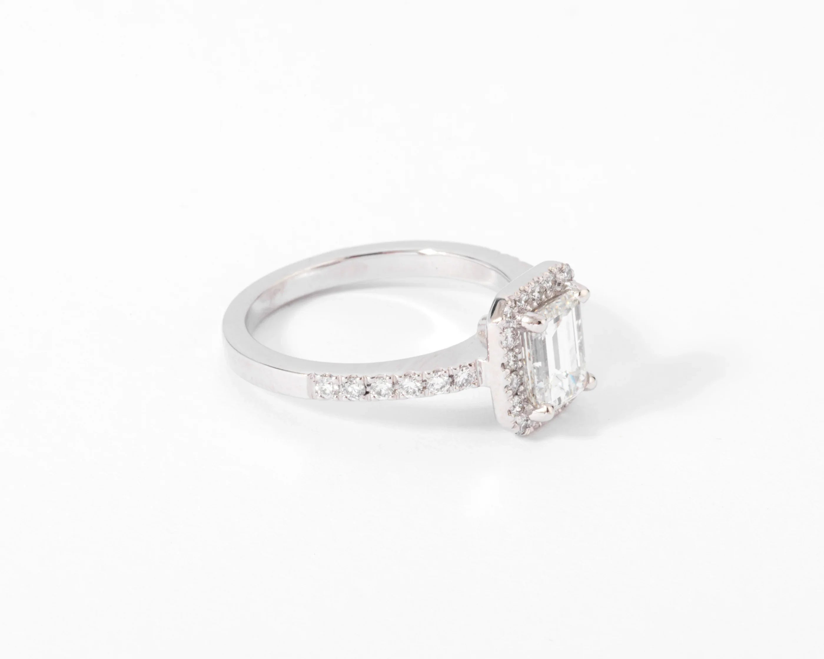 White gold solitaire ring with an emerald-cut diamond