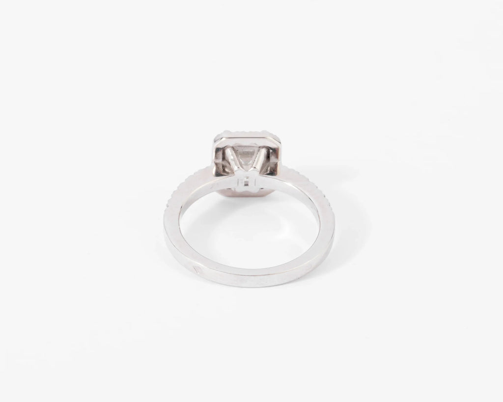 White gold solitaire ring with an emerald-cut diamond