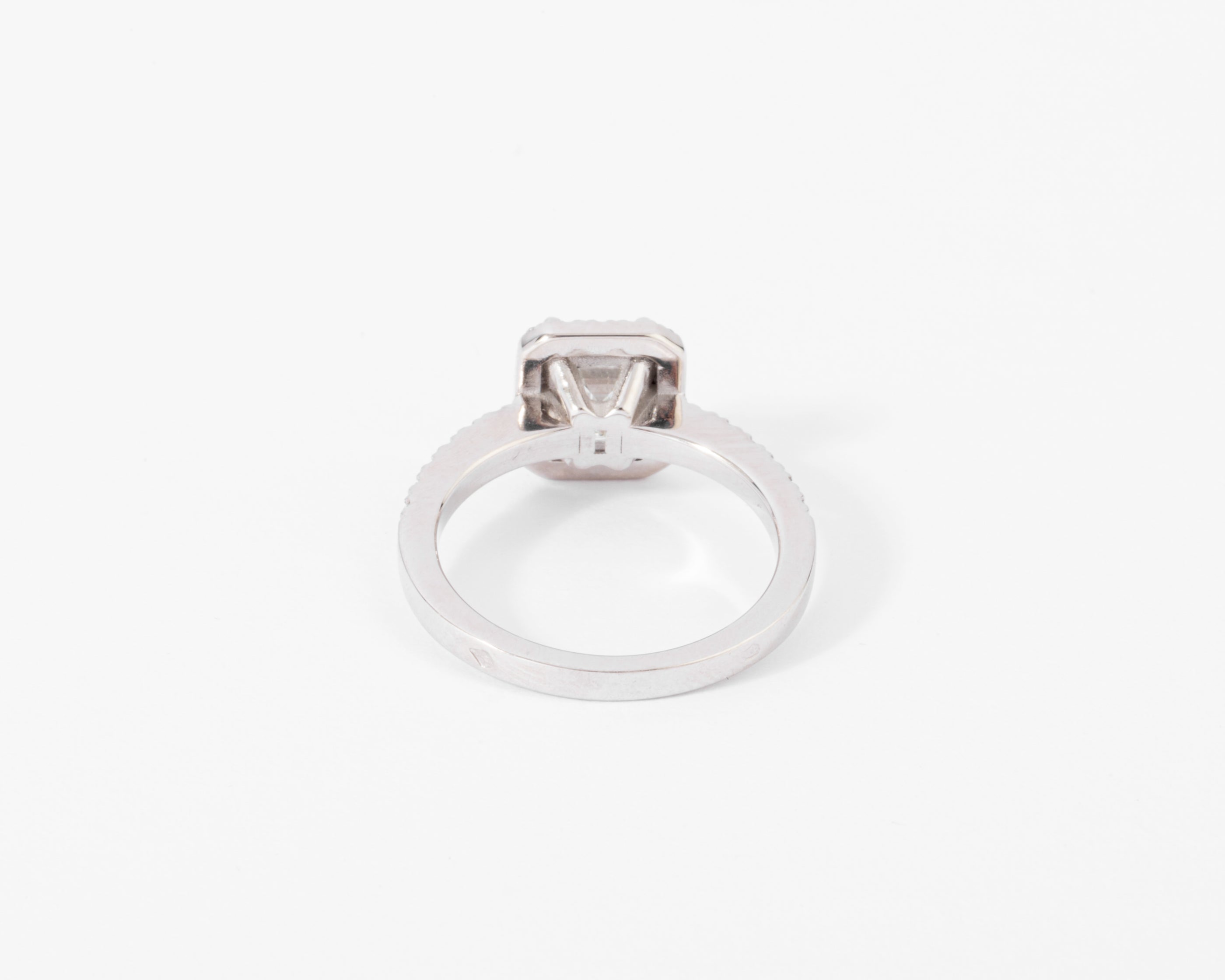 White gold solitaire ring with an emerald-cut diamond