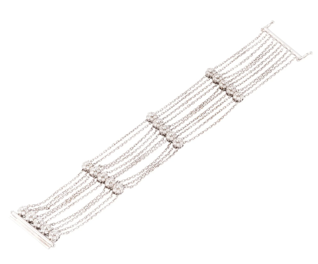 Grey gold and diamond bracelet on a filed cable chain alternating with 4 floral motifs