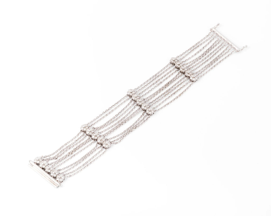 Grey gold and diamond bracelet on a filed cable chain alternating with 4 floral motifs
